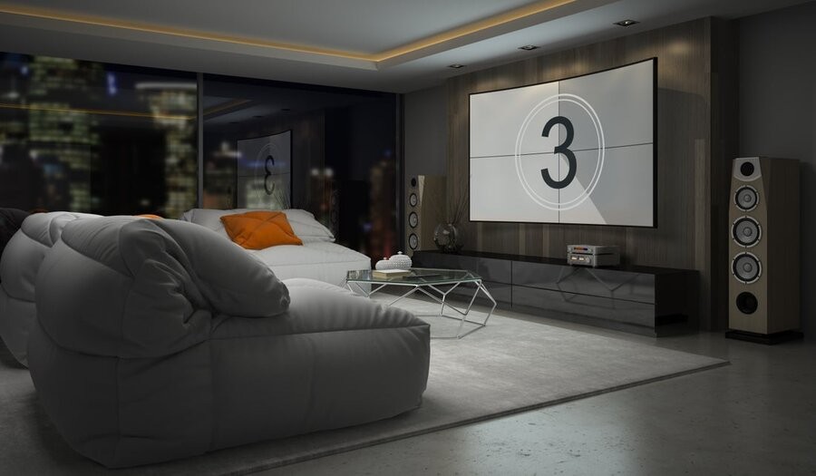 A dedicated home theater installation with a large display and comfy seating overlooking a city.