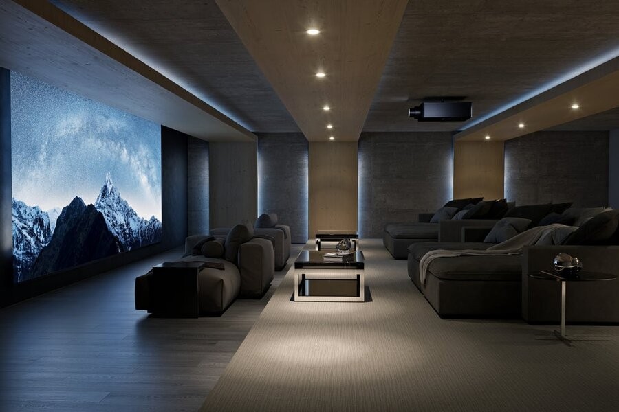 A luxurious home theater setup and design featuring comfy seats and a stunning projector and screen.