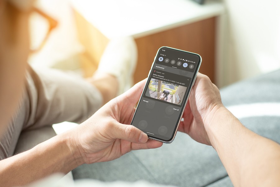 A homeowner watching her security cameras from her phone.