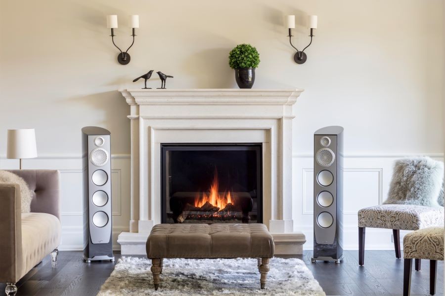 Paradigm loudspeakers next to a fireplace.