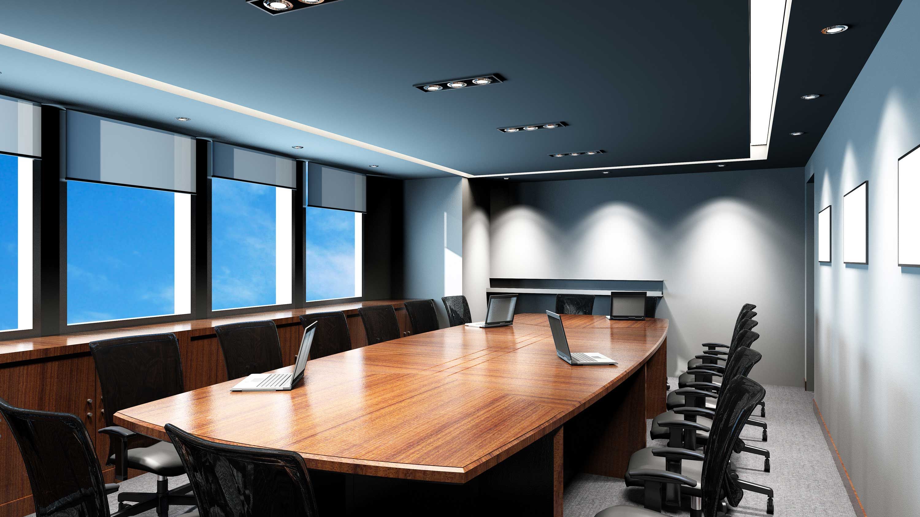 wooden conference table in a blue conference room