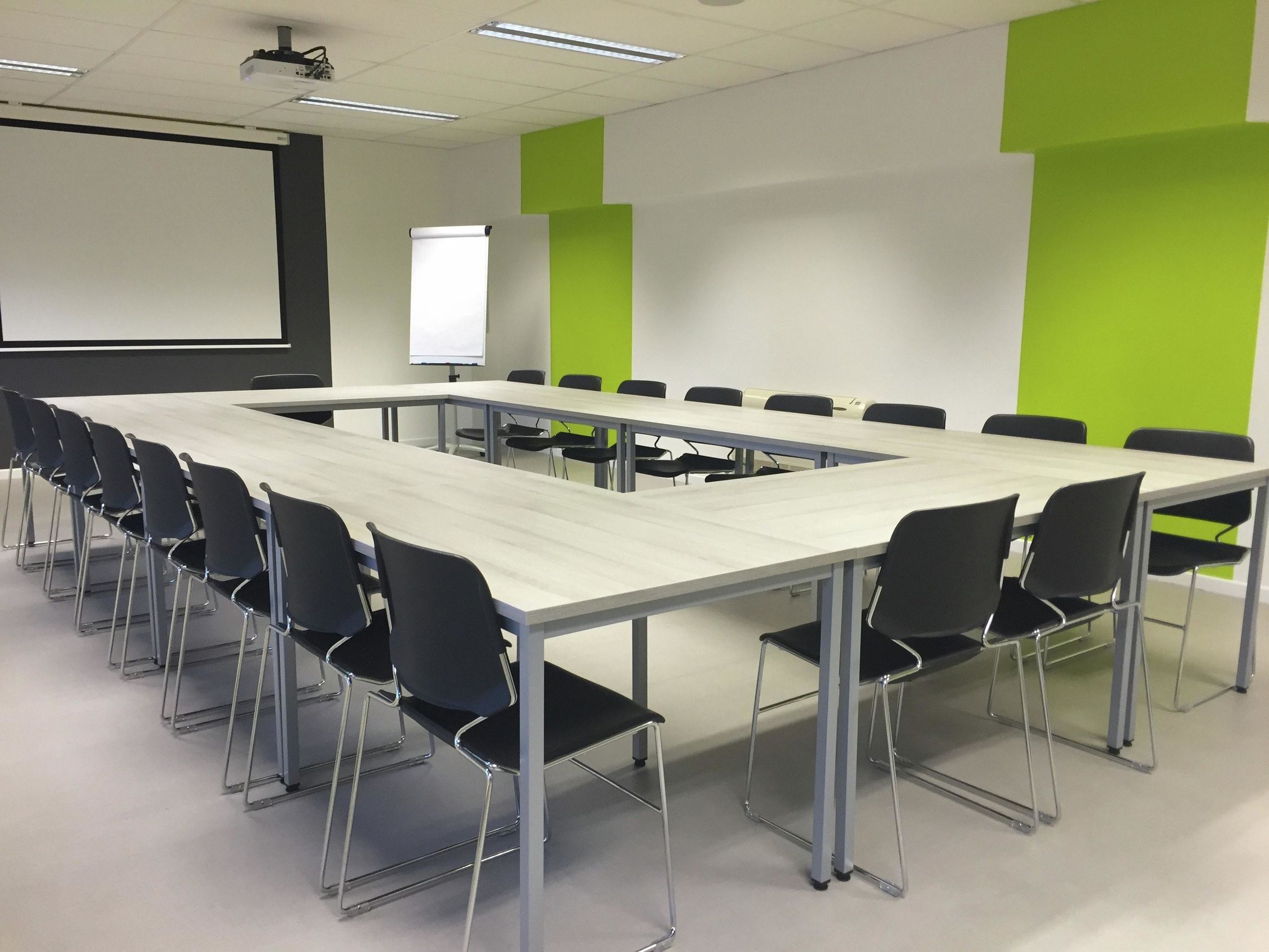 square training table with green striped walls