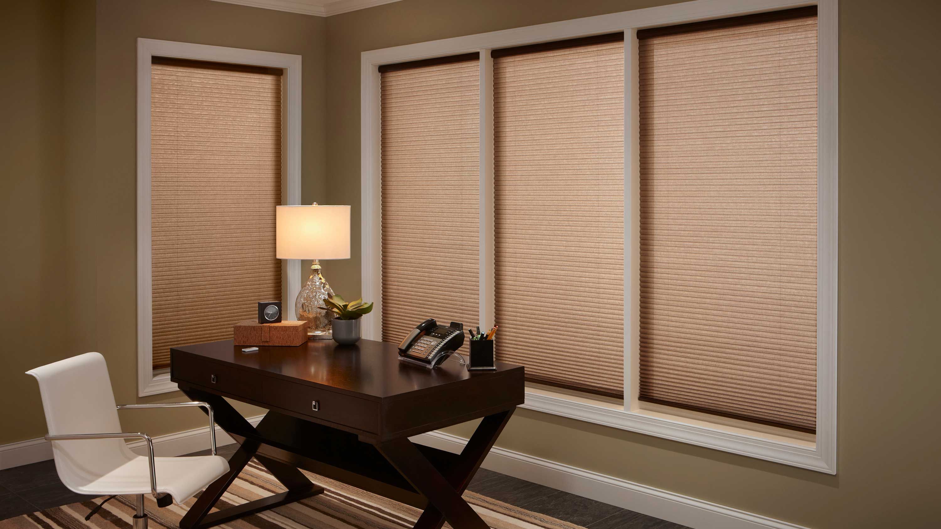 Lutron shades in home office with dark wood