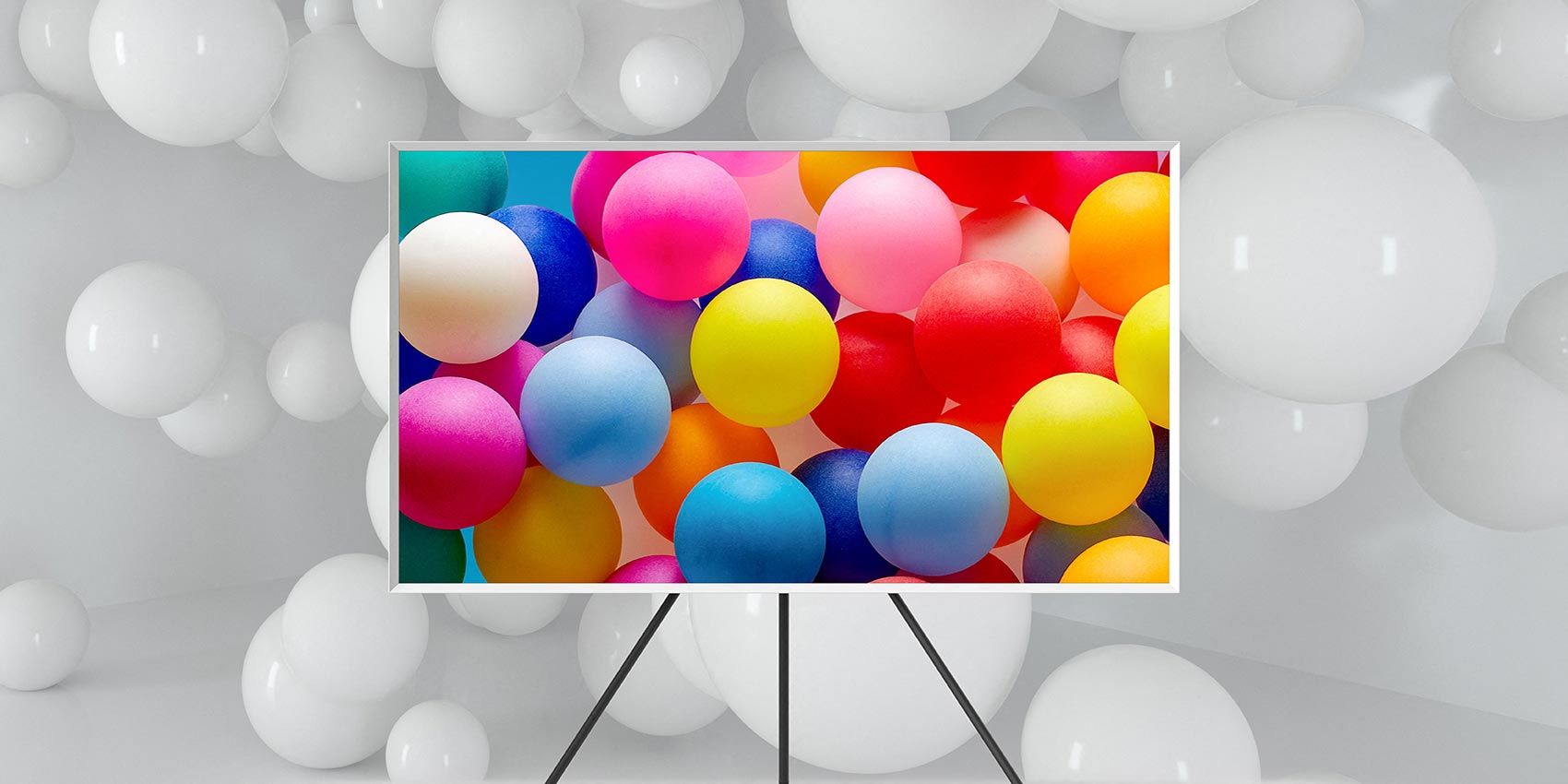 Samsung Frame TV in room with white balloons, colorful balloons