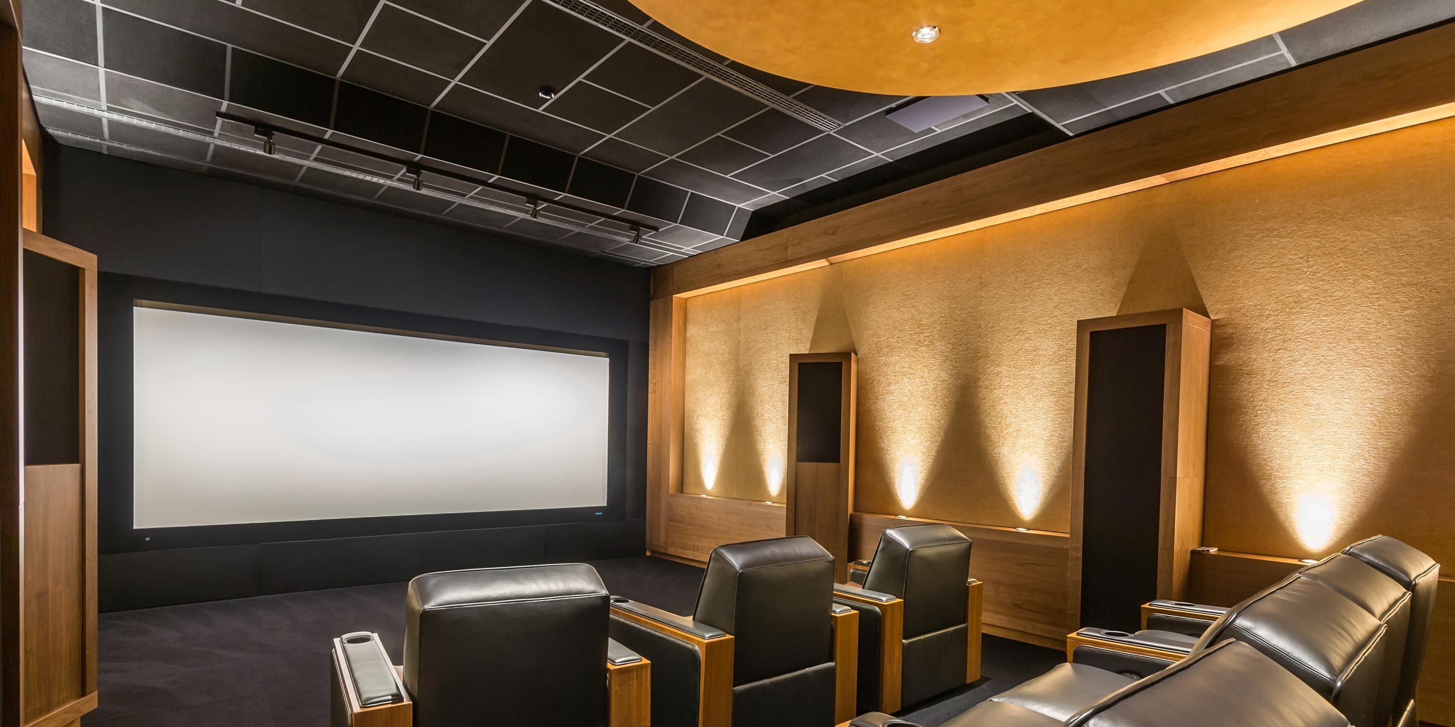 condo theater with yellow walls and grey ceiling